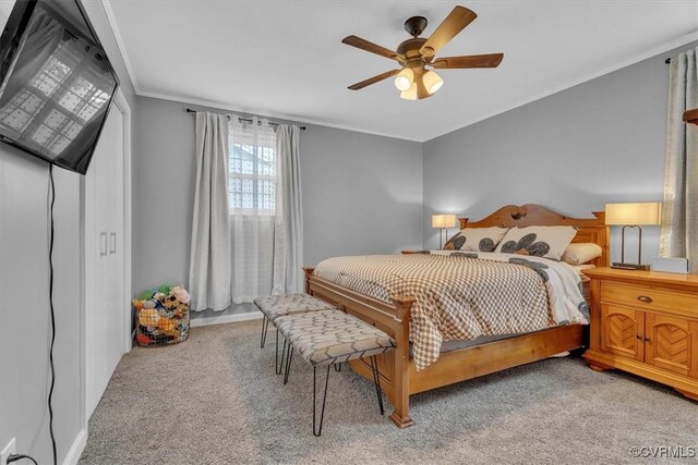 bedroom with crown molding, a ceiling fan, and light colored carpet