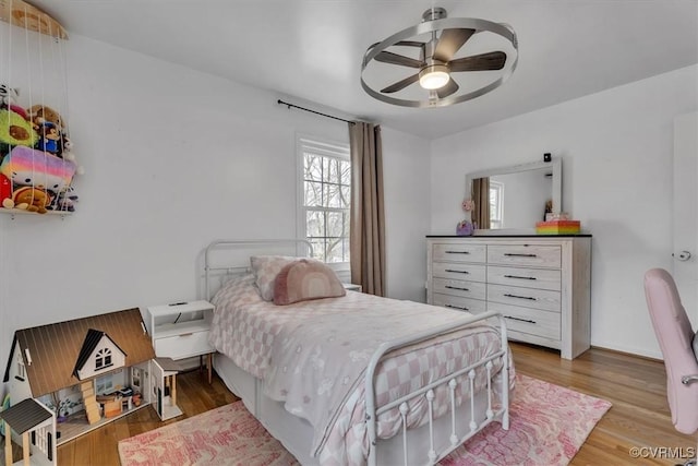 bedroom with a ceiling fan and wood finished floors