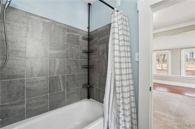 bathroom featuring shower / bath combo and crown molding