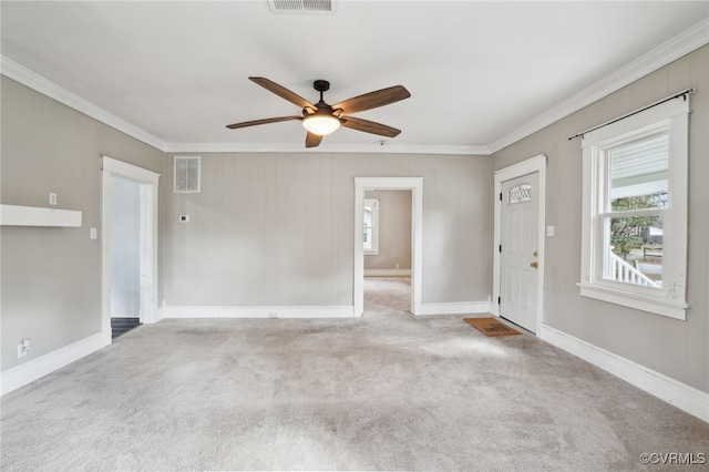 interior space with a ceiling fan, visible vents, baseboards, and crown molding