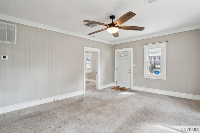 spare room featuring visible vents, crown molding, and carpet flooring