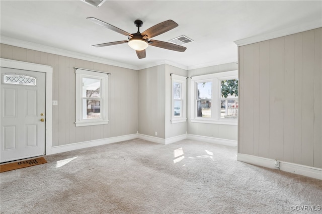 foyer with ornamental molding, a wealth of natural light, and visible vents