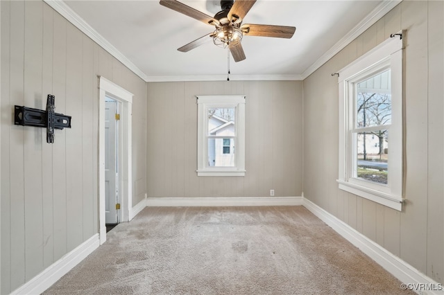 unfurnished room featuring baseboards, ornamental molding, ceiling fan, and carpet flooring