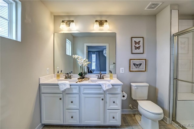 full bath with visible vents, a stall shower, a sink, and toilet