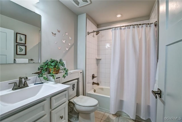 bathroom featuring toilet, vanity, visible vents, tile patterned floors, and shower / bath combo