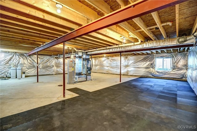 basement with water heater and heating unit