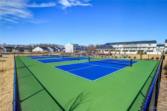 view of sport court with community basketball court, fence, and a residential view