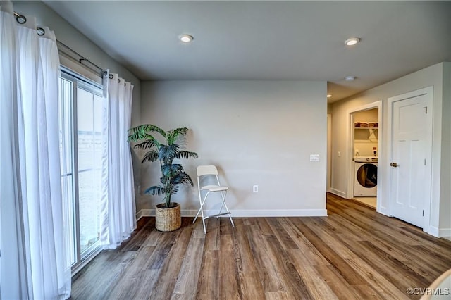 sitting room with recessed lighting, washer / clothes dryer, baseboards, and wood finished floors