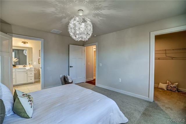 bedroom with a notable chandelier, a closet, visible vents, a spacious closet, and baseboards