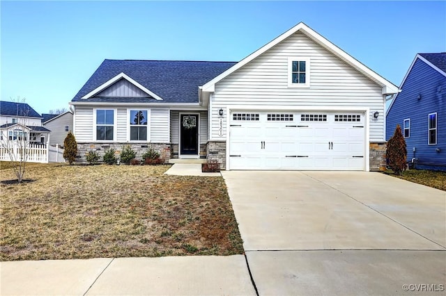 view of front of home featuring a garage, stone siding, and concrete driveway