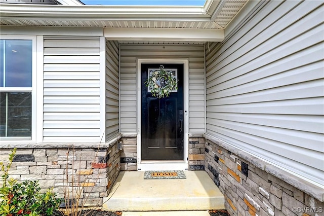 entrance to property featuring stone siding