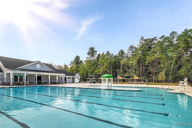 community pool featuring fence and a patio