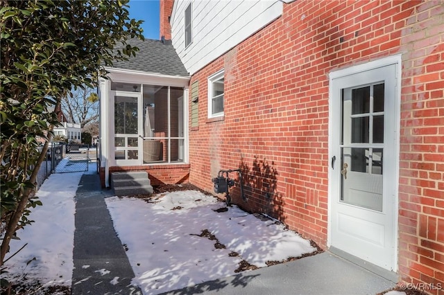 view of patio / terrace featuring a gate, fence, and a sunroom