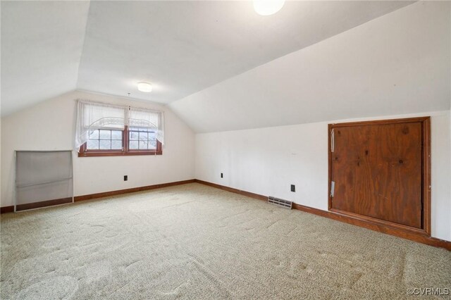 bonus room featuring visible vents, baseboards, carpet, and vaulted ceiling