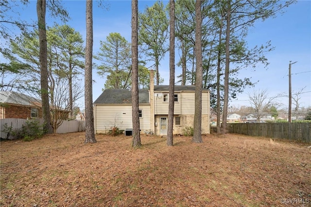 rear view of property with fence