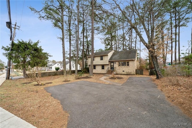 view of front of house with brick siding and driveway