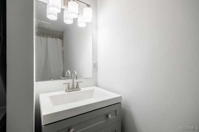 full bath with vanity and a shower with shower curtain