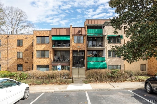 view of building exterior with uncovered parking