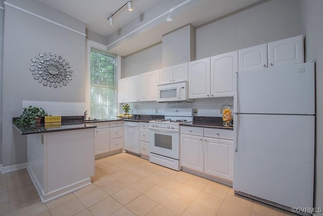 1005 W Franklin St Unit U2, Richmond, VA 23220 - kitchen with white appliances, dark countertops, white cabinets, and a sink