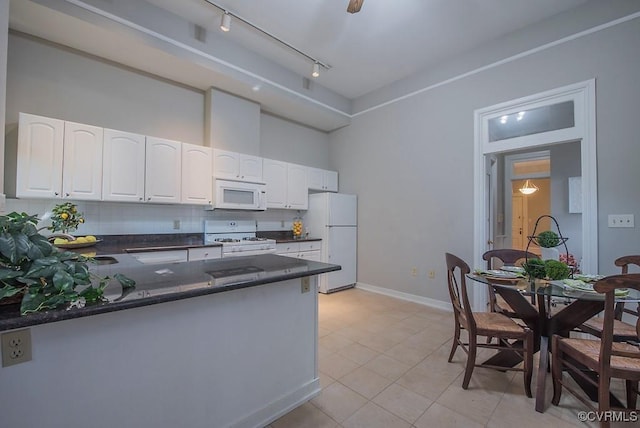 1005 W Franklin St Unit U2, Richmond, VA 23220 - kitchen featuring white cabinetry, tasteful backsplash, a peninsula, light tile patterned floors, and white appliances