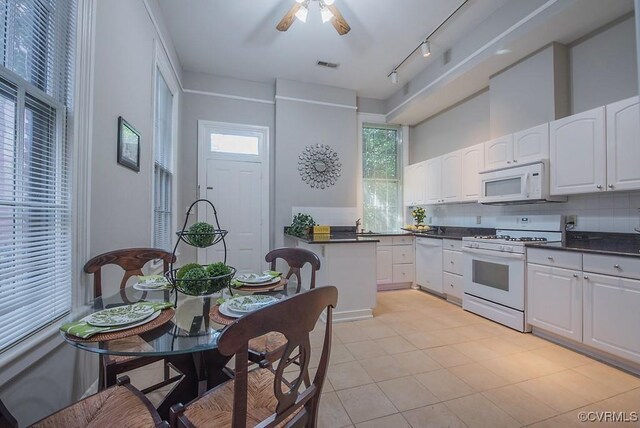 1005 W Franklin St Unit U2, Richmond, VA 23220 - kitchen featuring white appliances, visible vents, white cabinets, and tasteful backsplash