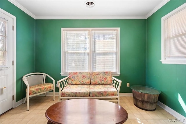 sitting room with baseboards, visible vents, and ornamental molding