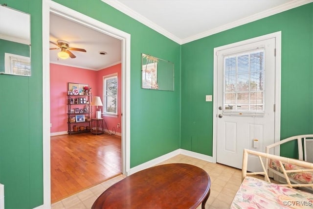 foyer featuring baseboards, a ceiling fan, and crown molding