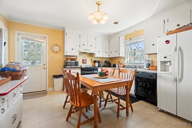 kitchen featuring an inviting chandelier, ornamental molding, black appliances, white cabinets, and under cabinet range hood