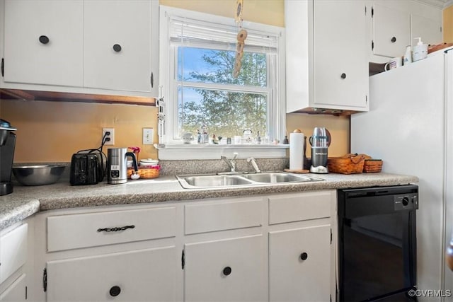 kitchen with dishwasher, white cabinetry, and a sink