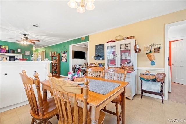 dining room with visible vents, crown molding, and ceiling fan with notable chandelier