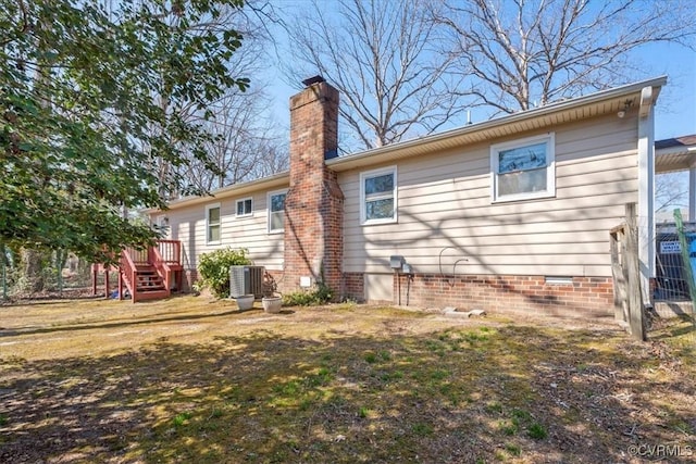 back of property with central air condition unit, a chimney, and crawl space