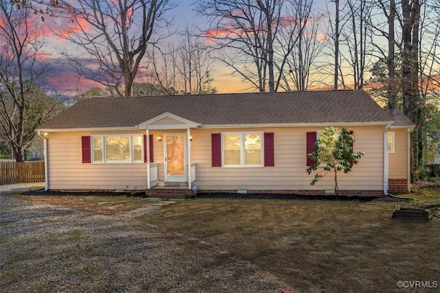 single story home with roof with shingles, a front lawn, and fence