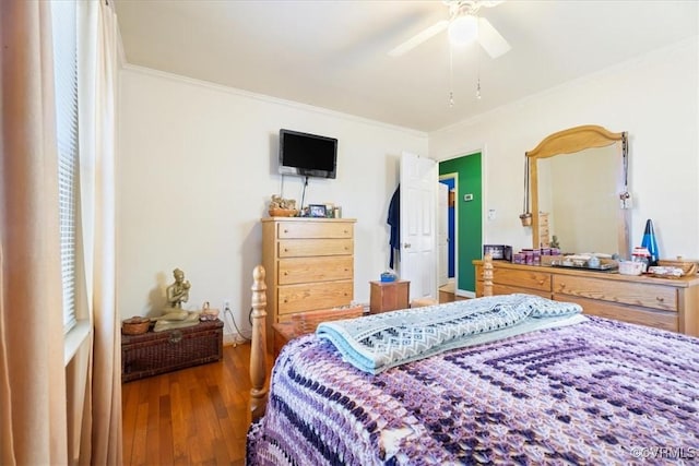 bedroom featuring a ceiling fan, wood finished floors, and crown molding