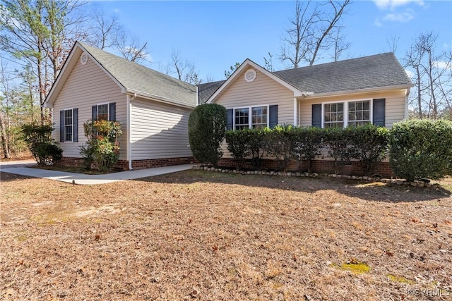 single story home featuring roof with shingles