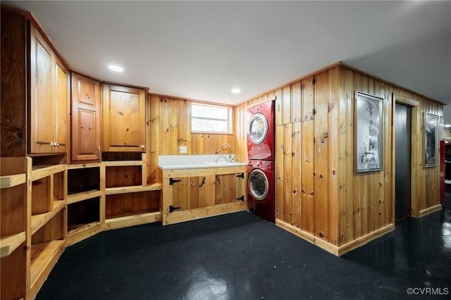 interior space with a sink and stacked washer / dryer