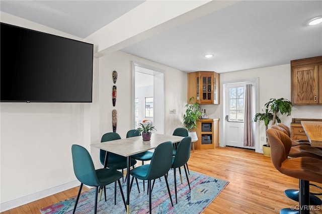 dining room with recessed lighting, baseboards, and light wood finished floors