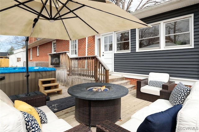 wooden deck with an outdoor living space with a fire pit and a hot tub