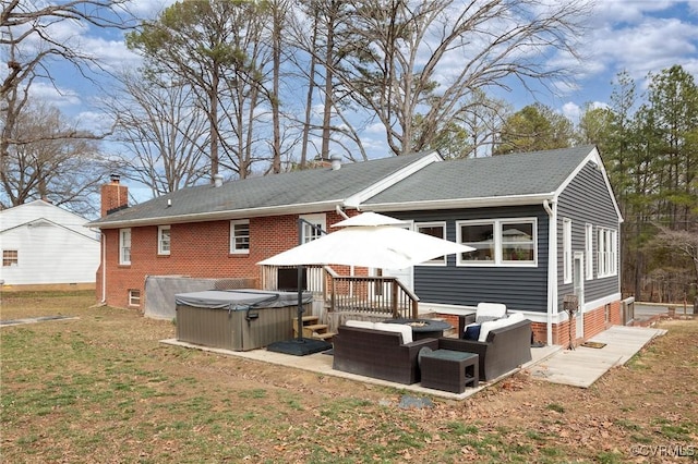 back of property with brick siding, an outdoor living space, a hot tub, a lawn, and a chimney