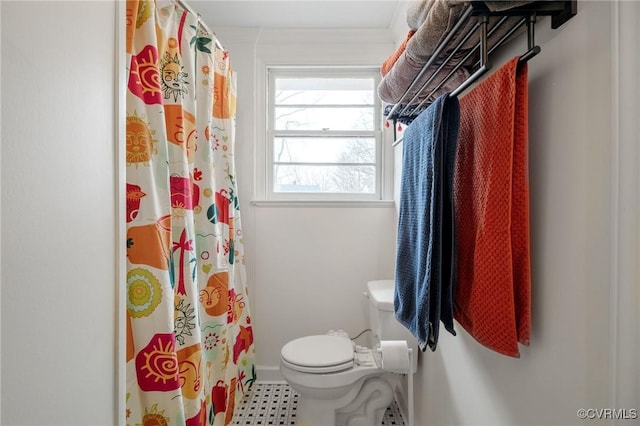 full bathroom with toilet and a shower with curtain