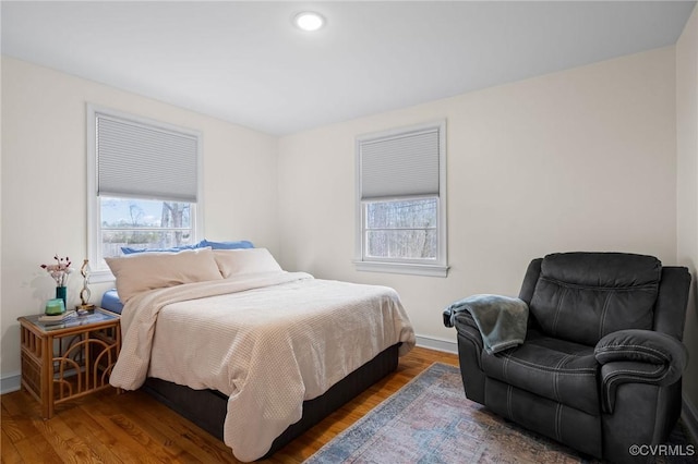 bedroom with recessed lighting, baseboards, and wood finished floors