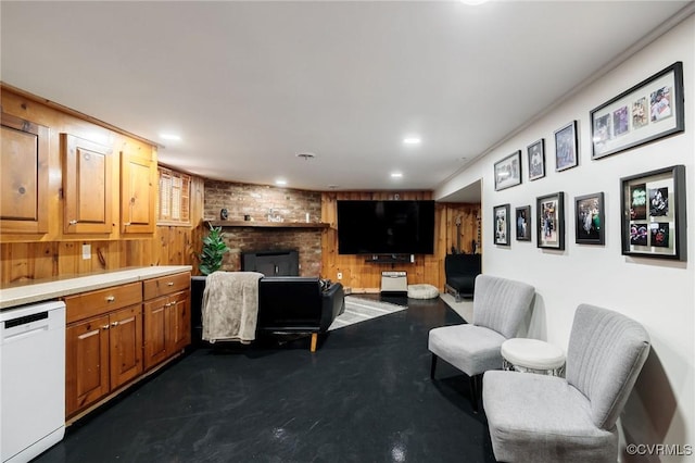 living area with recessed lighting and a brick fireplace