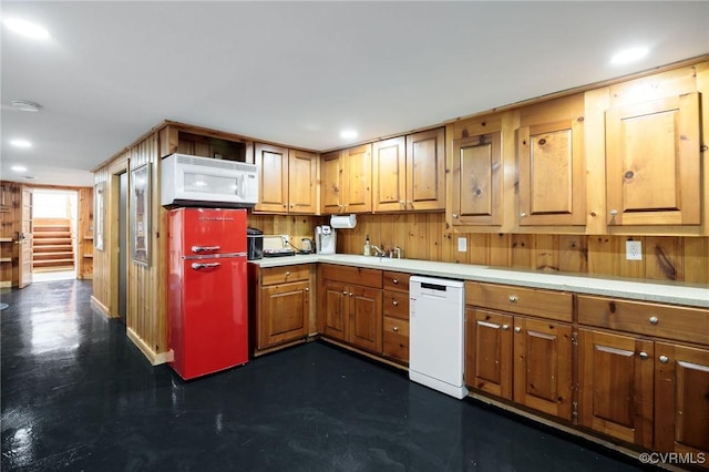 kitchen with recessed lighting, white appliances, brown cabinets, and light countertops