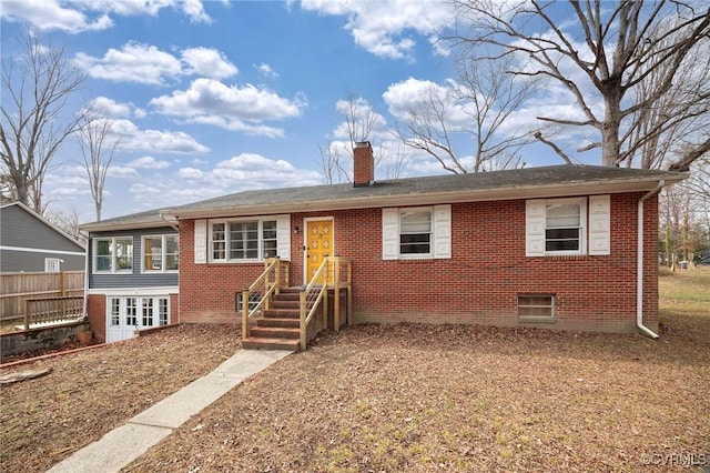 single story home with brick siding and a chimney