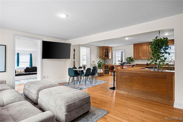 living room with light wood finished floors and recessed lighting