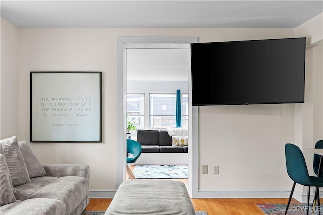 interior space featuring baseboards and wood finished floors