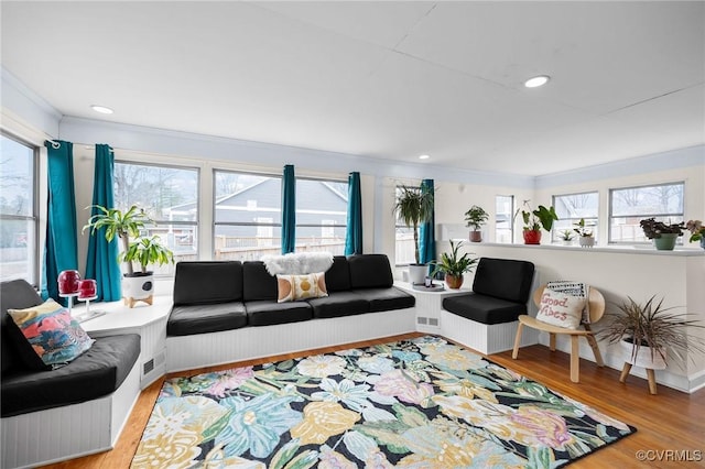 living area featuring a wealth of natural light, wood finished floors, and recessed lighting