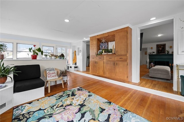 sitting room featuring recessed lighting, light wood-style floors, and a fireplace