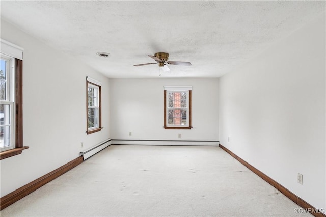 unfurnished room featuring carpet, visible vents, baseboards, ceiling fan, and a textured ceiling