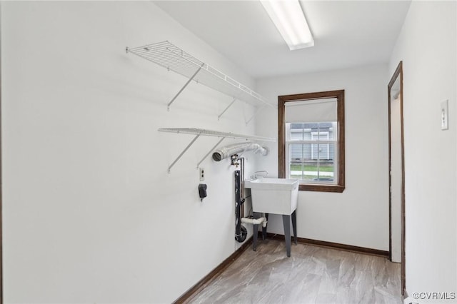 laundry area featuring baseboards