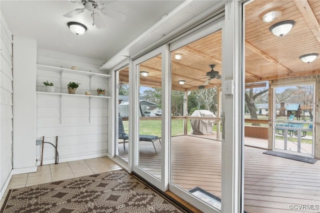 doorway to outside with tile patterned floors, a healthy amount of sunlight, and a ceiling fan